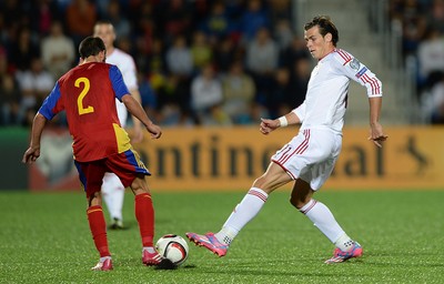 090914 - Andorra v Wales - 2016 Euro Qualifier -Gareth Bale of Wales is tackled by Christian Martinez of Andorra