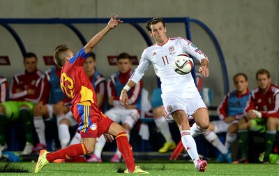 090914 - Andorra v Wales - 2016 Euro Qualifier -Gareth Bale of Wales is tackled by Jordi Rubio of Andorra