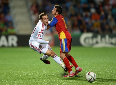 090914 - Andorra v Wales - 2016 Euro Qualifier -Aaron Ramsey of Wales is tackled by Christian Martinez of Andorra
