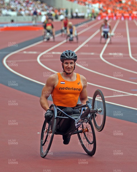 280713 - Sainsbury's Anniversary Games International Para Challenge at Olympic Stadium - Kenny Van Weeghel of Holland wins the Mens T54 200M event and celebrates with a wheelie for the camera's