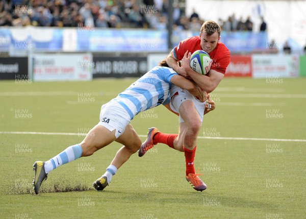 040619 - Argentina U20 v Wales U20 - World Rugby Under 20 Championship -  Cai Evans of Wales is tackled by Juan Pablo Castro