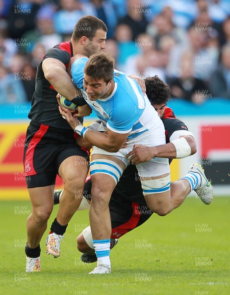 250915 - Argentina v Georgia - Rugby World Cup - Facundo Isa of Argentina is tackled by Mamuka Gorgodze and Viktor Kolelishvili of Georgia