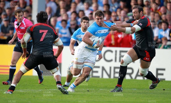 250915 - Argentina v Georgia - Rugby World Cup - Facundo Isa of Argentina is tackled by Mamuka Gorgodze of Georgia