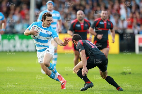 250915 - Argentina v Georgia - Rugby World Cup - Nicolas Sanchez of Argentina is tackled by Merab Kvirikashvili of Georgia