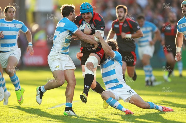 250915 - Argentina v Georgia - Rugby World Cup - Levan Datunashvili of Georgia is tackled by Tomas Cubelli and Nicolas Sanchez of Argentina