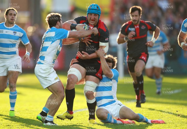 250915 - Argentina v Georgia - Rugby World Cup - Levan Datunashvili of Georgia is tackled by Tomas Cubelli and Nicolas Sanchez of Argentina