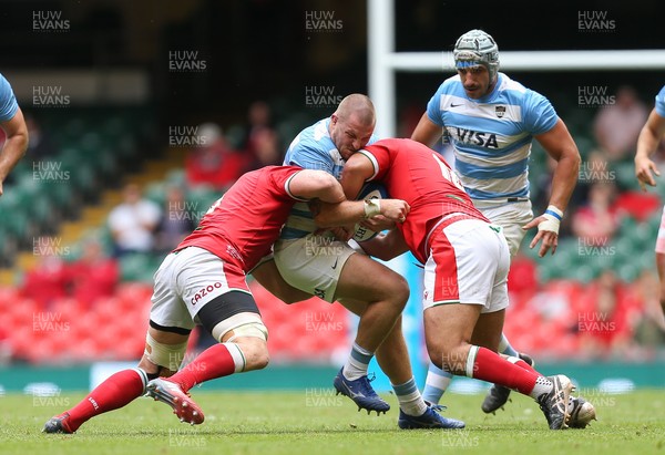 100721 - Argentina v Wales, Summer International First Test - Facundo Gigena of Argentina is tackled by Will Rowlands of Wales and Leon Brown of Wales