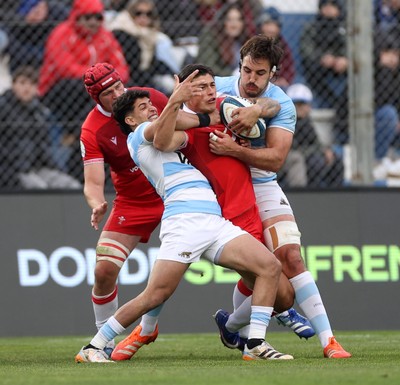 110726 - Argentina v Wales - Nations Championship - Louis Rees-Zammit of Wales is tackled by Simon Benitez Cruz of Argentina 