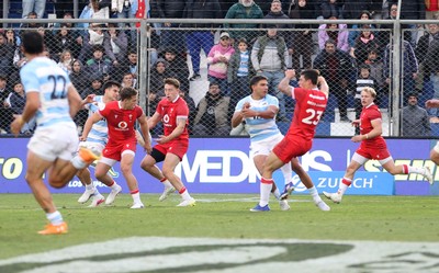 110726 - Argentina v Wales - Nations Championship - Louis Rees-Zammit of Wales is taken out by Santiago Carreras of Argentina 