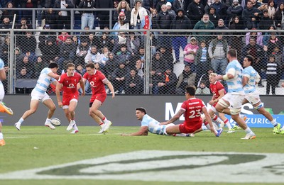 110726 - Argentina v Wales - Nations Championship - Louis Rees-Zammit of Wales is taken out by Santiago Carreras of Argentina 