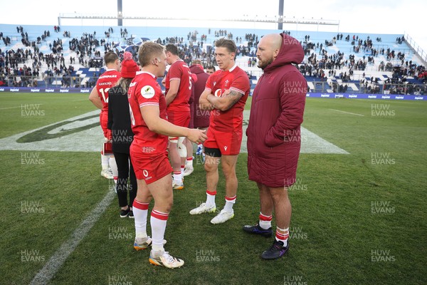 110726 - Argentina v Wales - Nations Championship - Sam Costelow, Josh Adams and Dillon Lewis of Wales at full time