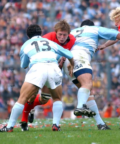 19-06-04. Argentina v Wales (Second Test Buenos Aires)  Wales' Dafydd Jones is caught by Jose Orengo and Federico Mendez (rt) as he tries to drive through.  