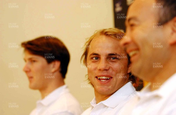 110603 - Australia Rugby Team Announcement - Wallabies' Phil Waugh looks to coach Eddie Jones, flanked by new boy Daniel Heenan (left), who will win his first Aussie cap when he faces wales on Saturday