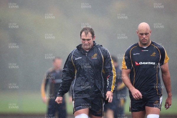 04.11.10..Australia Rugby Training session, University Playing Field, Treforest-  Australia's captain Rocky Elsom (left) and Nathan Sharpe during a wet training session at Treforest near Cardiff 