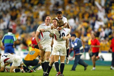 221103 - Australia v England - Rugby World Cup Final - England's Lawrence Dallaglio, Will Greenwood and Jason Robinson congratulate Jonny Wilikinson on his drop goal