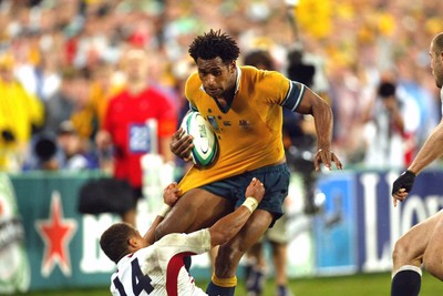 221103 - Australia v England - Rugby World Cup Final - Australias Lote Tuqiri is brought down by Jason Robinson