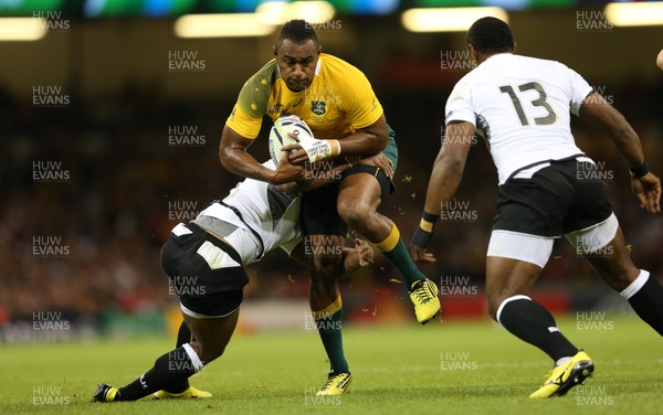 230915 - Australia v Fiji, Rugby World Cup 2015 - Tevita Kuridrani of Australia is tackled by Gabiriele Lovobalavu of Fiji as Vereniki Goneva of Fiji looks on