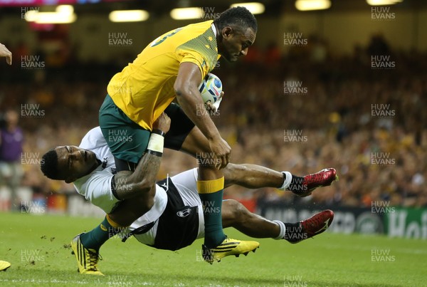 230915 - Australia v Fiji, Rugby World Cup 2015 - Tevita Kuridrani of Australia is tackled by Nikola Matawalu of Fiji