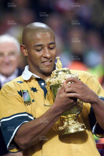 061199 - Australia v France - Rugby World Cup Final -  Australian scrum-half George Gregan hugs the trophy