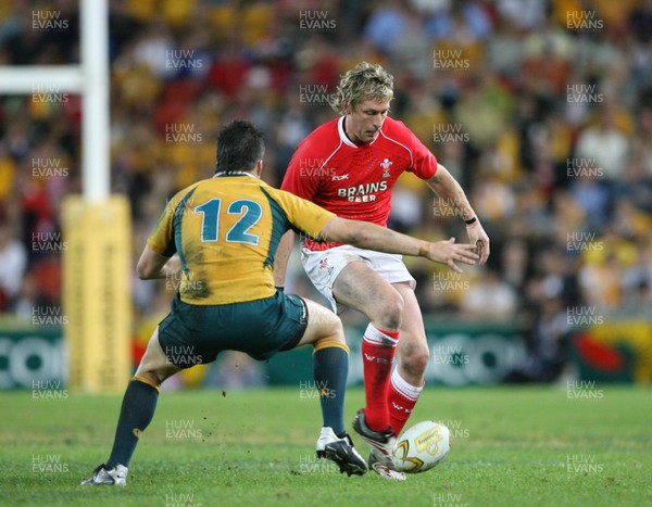 02.06.07 AUSTRALIA v WALES, 2nd Test ,Brisbane. Wales Jamie Robinson kicks past  Adam Asley-Cooper 