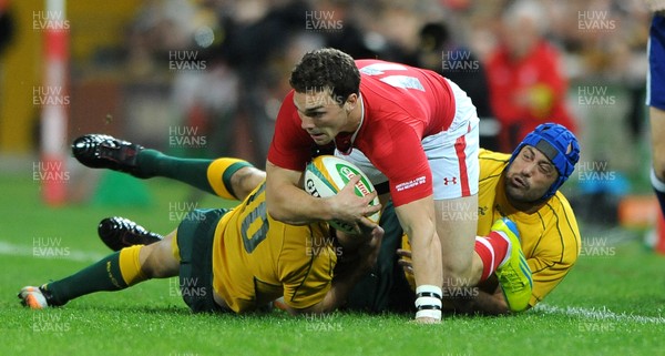 090612 - Australia v Wales - Castrol EDGE Series -George North of Wales is tackled by Nathan Sharpe and Berrick Barnes of Australia