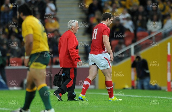 090612 - Australia v Wales - Castrol EDGE Series -George North of Wales leaves the field with Wales team doctor Professor John Williams