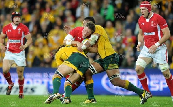 090612 - Australia v Wales - Castrol EDGE Series -Rhys Priestland of Wales takes on Rob Simmons and Wycliff Palu of Australia