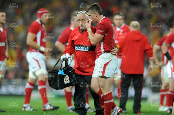 090612 - Australia v Wales - Castrol EDGE Series -Scott Williams of Wales leaves the field with Wales team doctor Professor John Williams