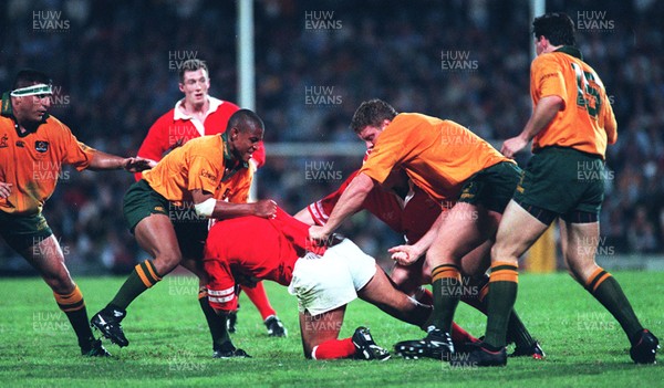 090696 - Australia v Wales - 1st Test - Hemi Taylor of Wales is tackled by George Gregan as Rob Howley supports  