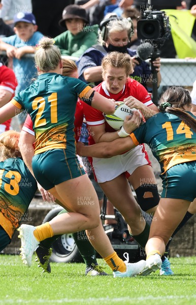 221022 - Australia v Wales, Women’s Rugby World Cup, Pool A - Lisa Neumann of Wales is tackled by  Layne Morgan of Australia and Bienne Terita of Australia