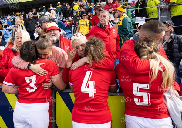 221022 - Australia v Wales, Women’s Rugby World Cup, Pool A - Cerys Hale, Natalia John and Gwen Crabb of Wales are consoled by their families and supporters at the end of them match