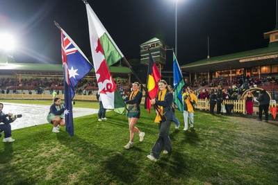 010825 - Australia Women v Wales Women - Flag bearers walk out at the start of the match