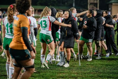 010825 - Australia Women v Wales Women - Alex Callender of Wales on crutches is embraced by Carys Cox of Wales at the end of the match