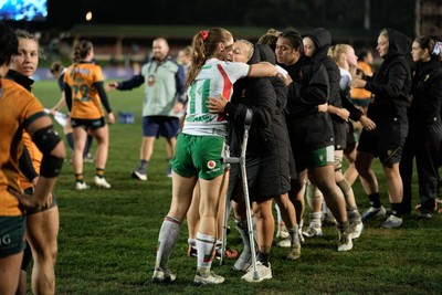 010825 - Australia Women v Wales Women - Alex Callender of Wales on crutches is embraced by Lisa Neumann of Wales at the end of the match