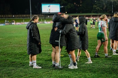 010825 - Australia Women v Wales Women - Alex Callender of Wales on crutches is embraced team mates at the end of the match