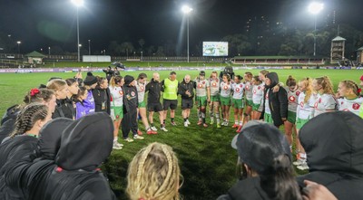010825 - Australia Women v Wales Women - Sean Lynn, Wales Women head coach, speaks to the players as the Wales team huddle up at the end of the match