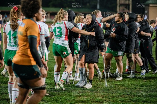 010825 - Australia Women v Wales Women - Alex Callender of Wales on crutches is embraced by Carys Cox of Wales at the end of the match