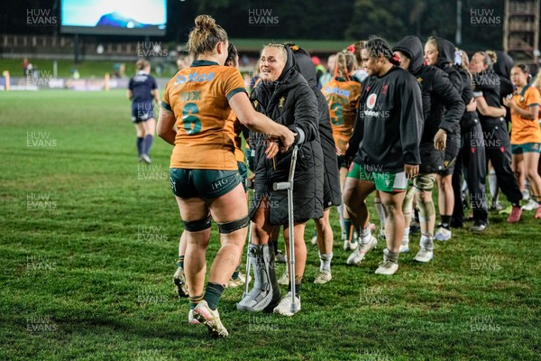 010825 - Australia Women v Wales Women - Alex Callender of Wales on crutches congratulates the Australian team
