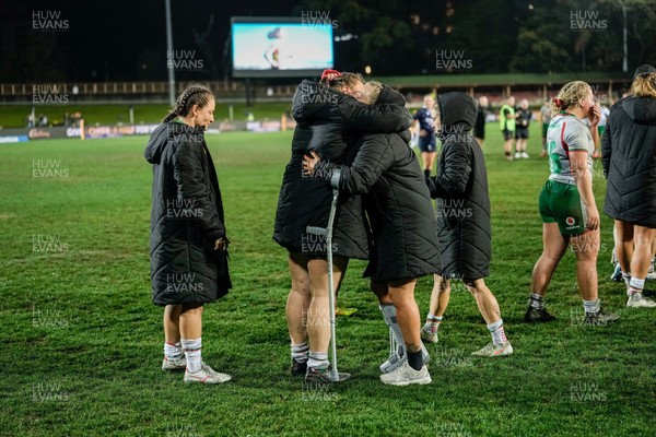010825 - Australia Women v Wales Women - Alex Callender of Wales on crutches is embraced team mates at the end of the match