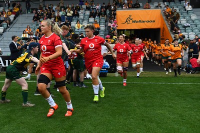 260725 - Australia Women v Wales Women - Alex Callender of Wales runs out at the start of the match