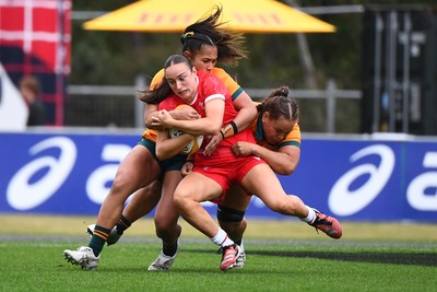 260725 - Australia Women v Wales Women - Nel Metcalfe of Wales is tackled