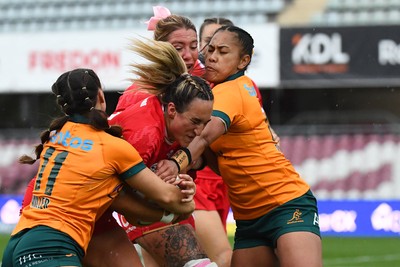260725 - Australia Women v Wales Women - Courtney Keight of Wales is tackled