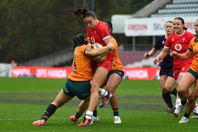 260725 - Australia Women v Wales Women - Nel Metcalfe of Wales is tackled