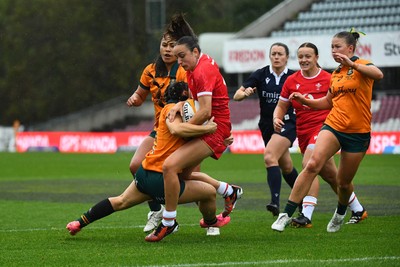 260725 - Australia Women v Wales Women - Nel Metcalfe of Wales is tackled