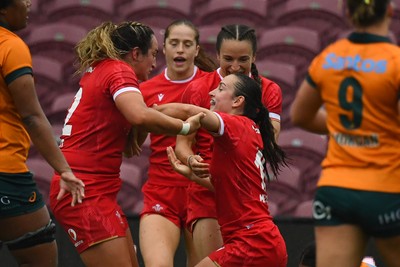 260725 - Australia Women v Wales Women - Nel Metcalfe of Wales is congratulated by Courtney Keight of Wales after her second try