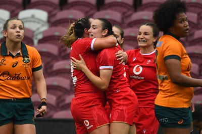 260725 - Australia Women v Wales Women - Nel Metcalfe of Wales is congratulated by Courtney Keight of Wales after her second try