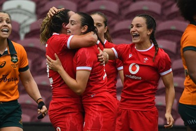 260725 - Australia Women v Wales Women - Nel Metcalfe of Wales is congratulated by Courtney Keight of Wales and Jasmine Joyce of Wales after her second try
