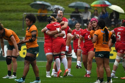260725 - Australia Women v Wales Women - Sisilia Tuipulotu of Wales, Bethan Lewis of Wales and Bryonie King of Wales celebrate on the final whistle