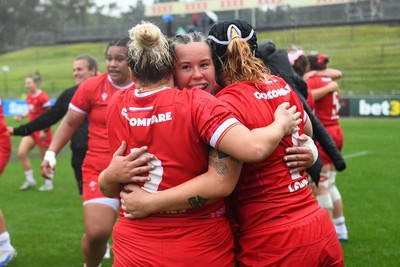 260725 - Australia Women v Wales Women - Katherine Baverstock of Wales, Molly Reardon of Wales and Bethan Lewis of Wales celebrate at the end of the match