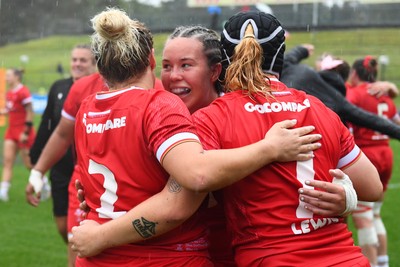 260725 - Australia Women v Wales Women - Katherine Baverstock of Wales, Molly Reardon of Wales and Bethan Lewis of Wales celebrate at the end of the match